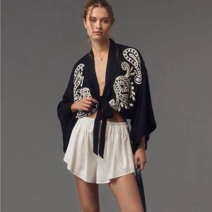 By Anthropologie embellished tie front top.